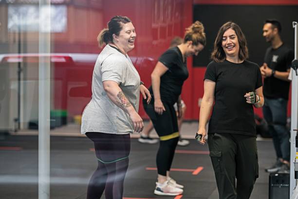 happy women attending group fitness class
